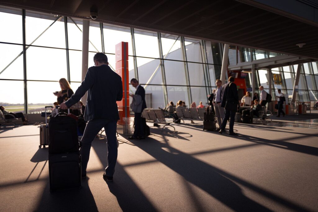 Travellers with luggage in a bright airport terminal
